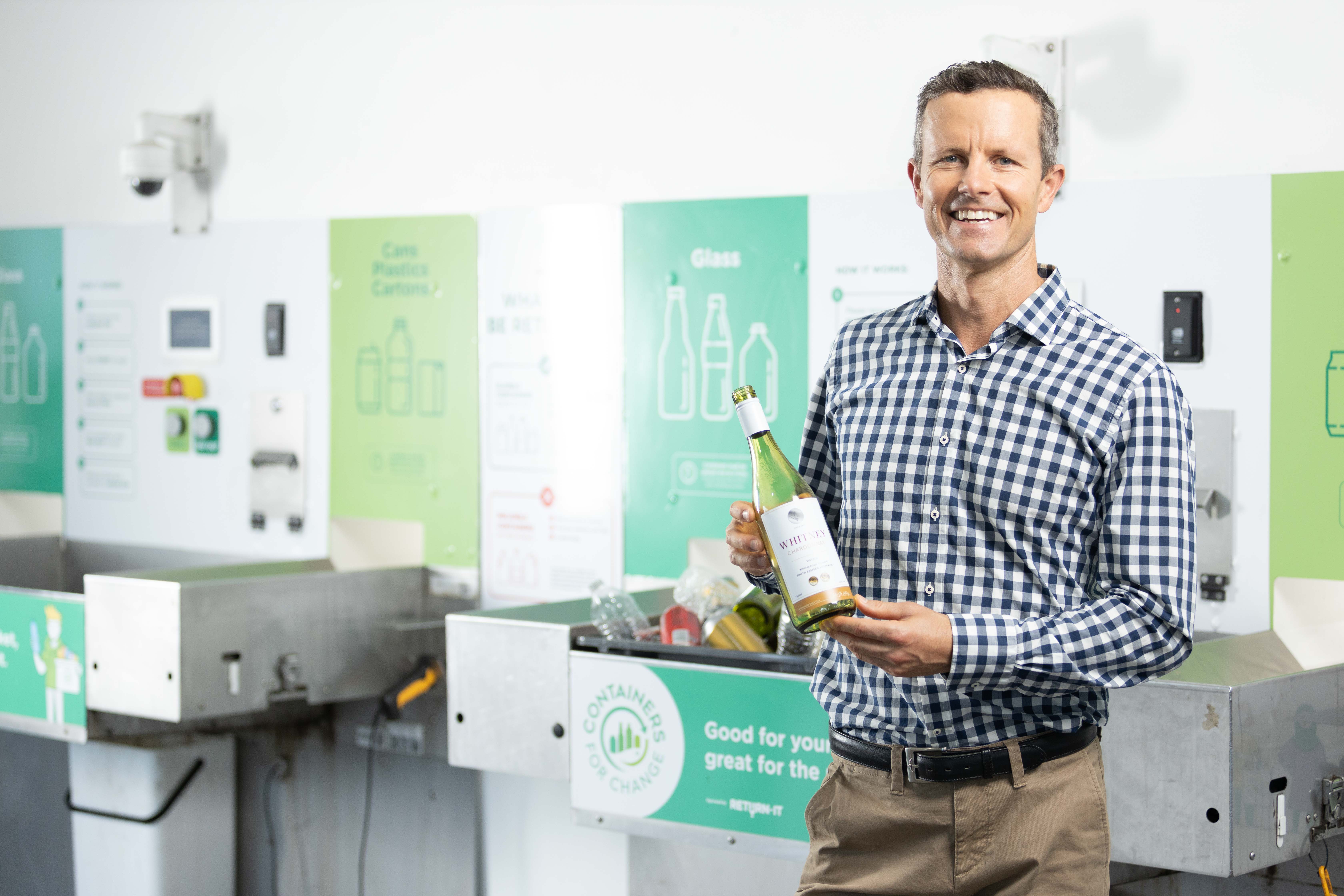 Man holding wine bottle at Refund Point