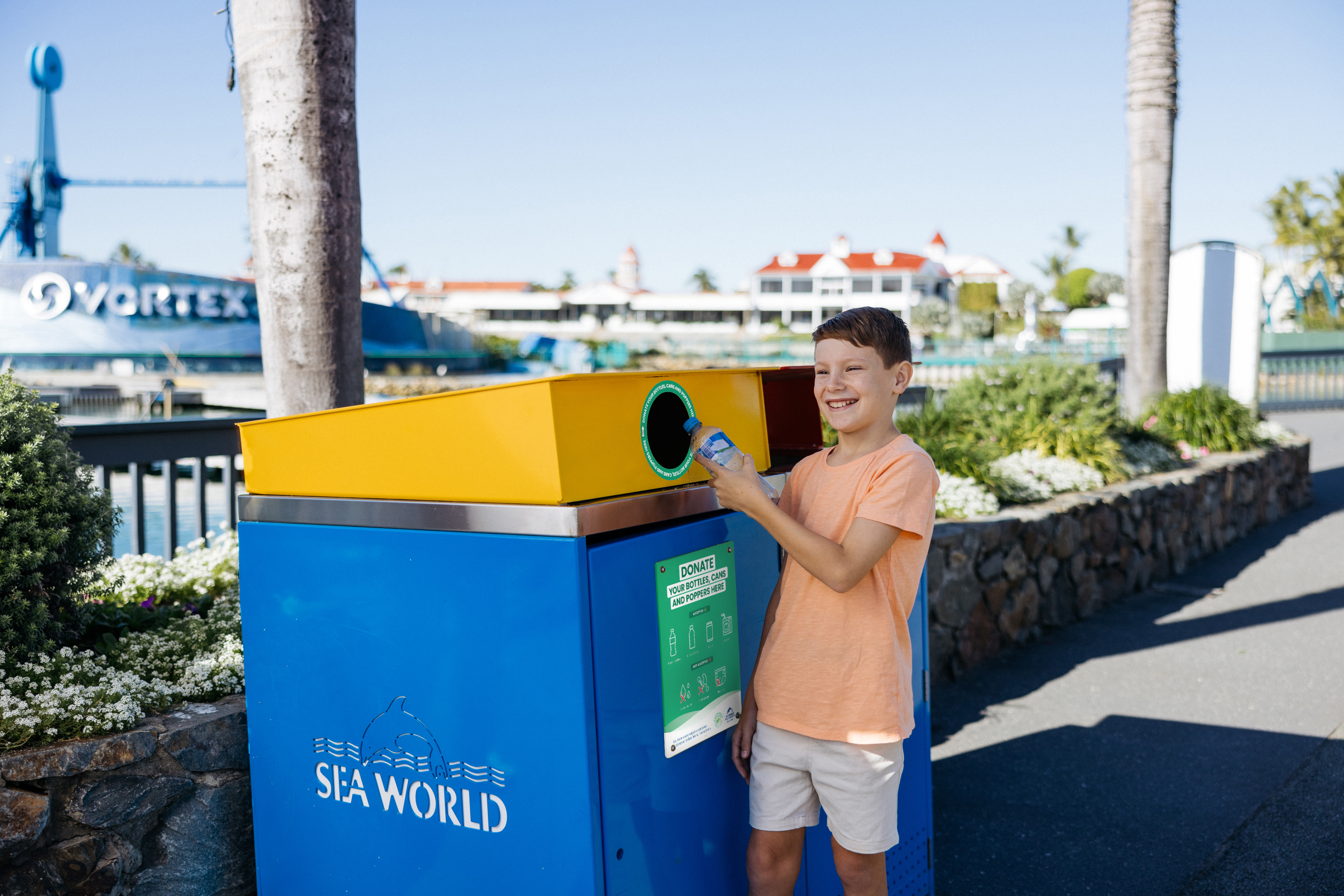 Child putting container in bin