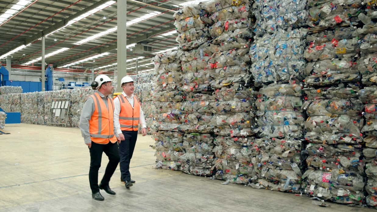 Two men walking in factory