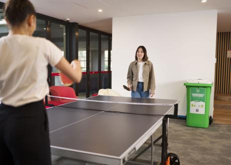 Two millennials playing table tennis
