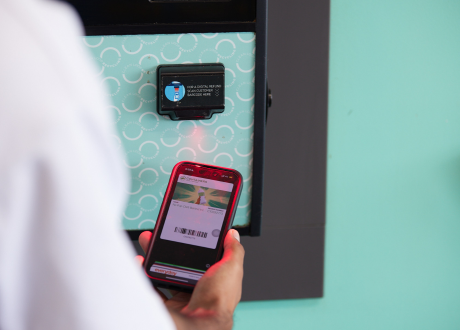 person using their member number to scan containers