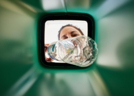 women placing a bottle in the bin from inside in the bin